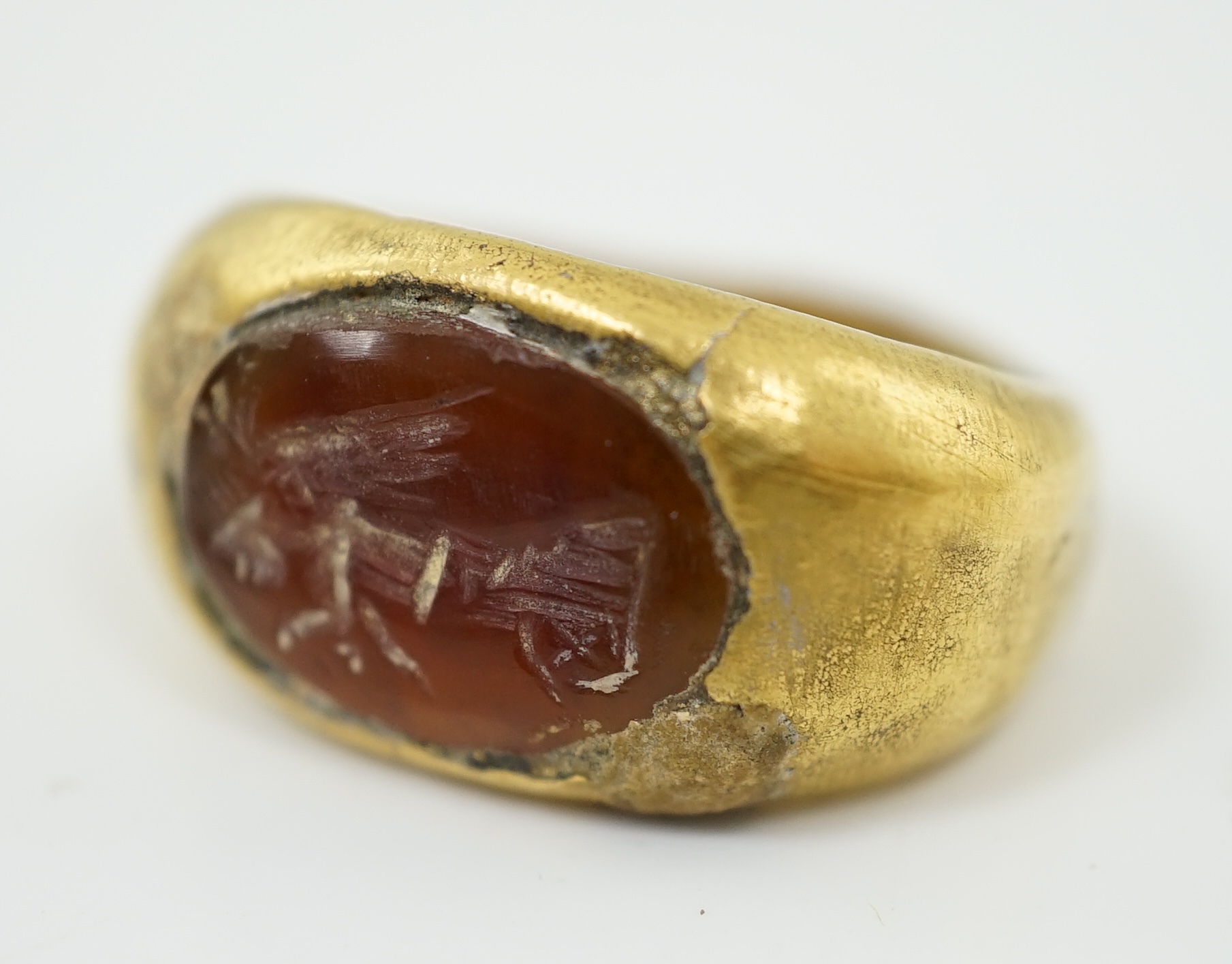 A Greco-Roman gold and intaglio carnelian set finger ring, carved with the figure of Nike, circa 1st century B.C.